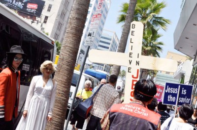 A Michael Jackson and Marilyn Monroe pair of street performers looks on as a small Korean religious group marches on carrying signs advocating Jesus Christ along Hollywood Blvd. First place: Karen Zhou, freelance, "Marilyn and Michael and Jesus"