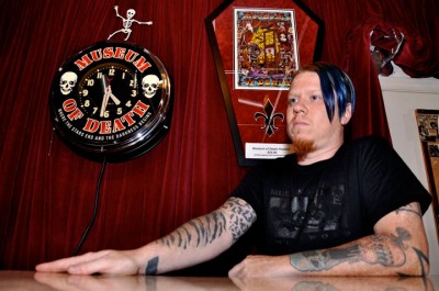 Erek Michael, manager at The Museum of Death poses in front the museum's clock & poster. "Museum of Death Worker" Sixth place: Karen Zhou, freelance