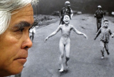 Nick Ut with his Pulitzer Prize winning photograph 'Napalm Girl' from the Vietnam War. Photo courtesy of Ringo Chiu